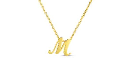 a yellow gold pendant necklace featuring an “M” motif
