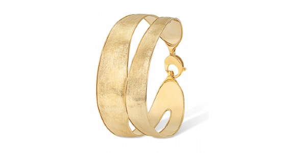 a yellow gold cuff bracelet with a big, bold silhouette