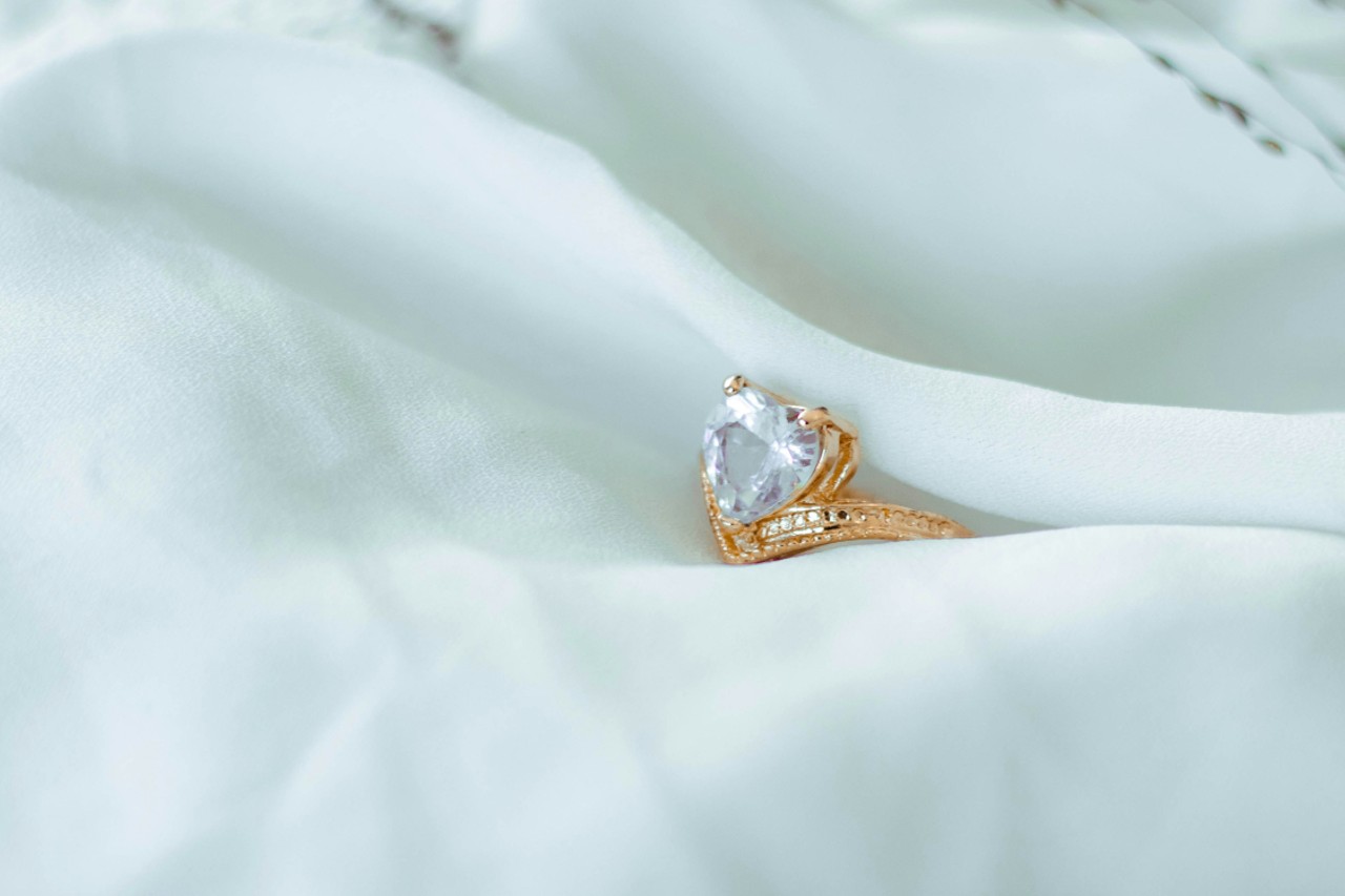 A heart shape diamond set onto a yellow gold band