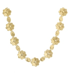 A gold floral necklace from Marco Bicego features diamond accents.