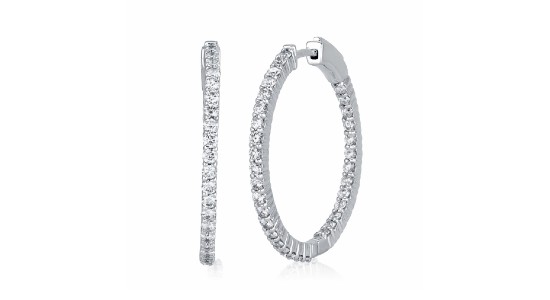 a pair of large white gold hoop earrings set with round cut diamonds