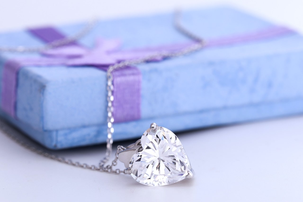 a white gold diamond pendant necklace featuring a heart shaped diamond