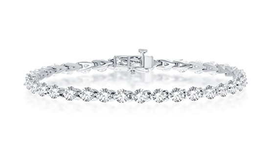 a white gold tennis bracelet featuring round cut diamonds