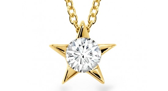 a yellow gold pendant necklace featuring a diamond and a star motif
