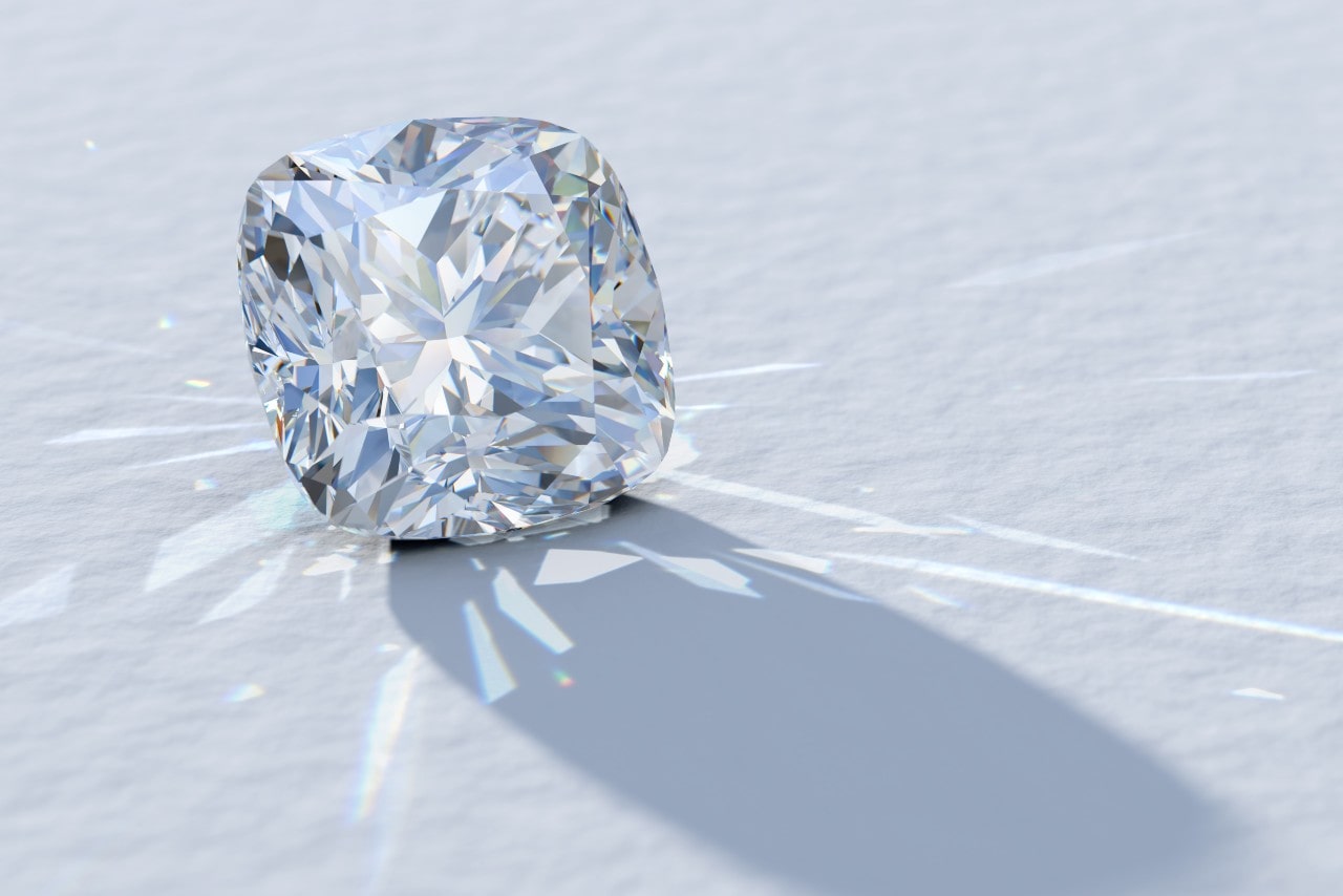 A cushion cut diamond in the light on a white background