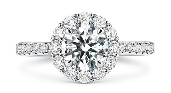 a white gold halo engagement ring with a round cut center stone and side stones