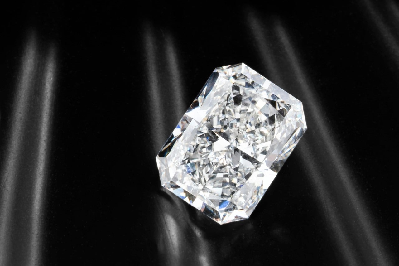 a radiant cut loose diamond on a black silk background