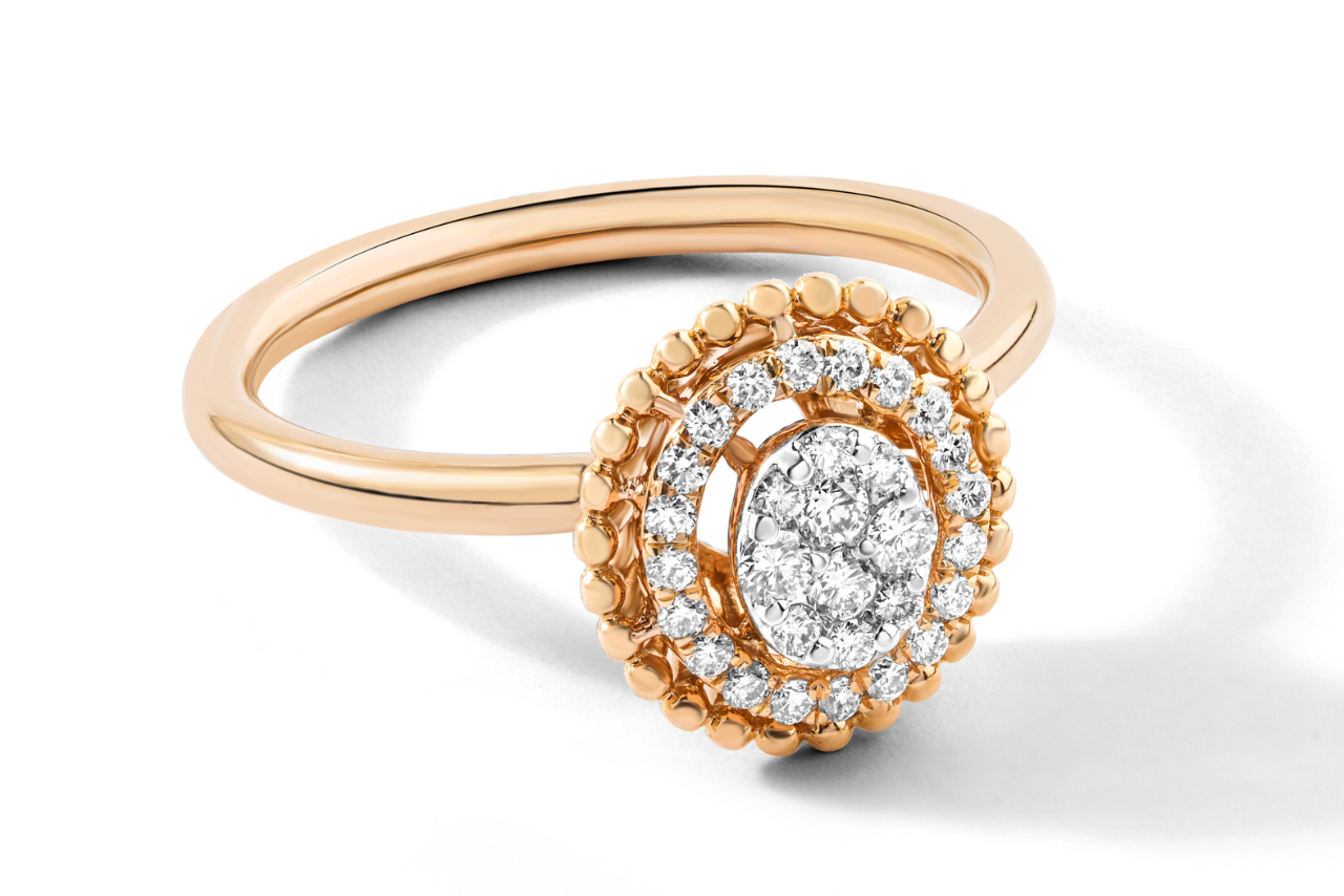 Rose gold ring featuring an intricate oval halo setting paved with small, shimmering white diamonds on a plain white background.
