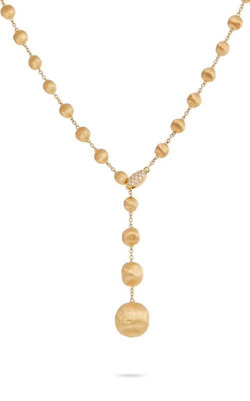 A gold pleated lariat necklace on a white background