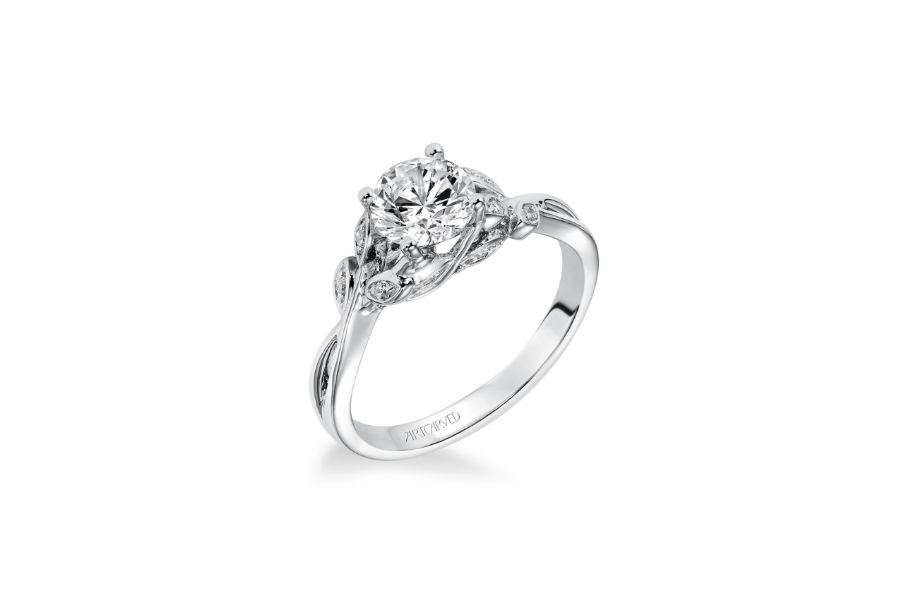 A floral-inspired engagement ring with a round cut diamond.
