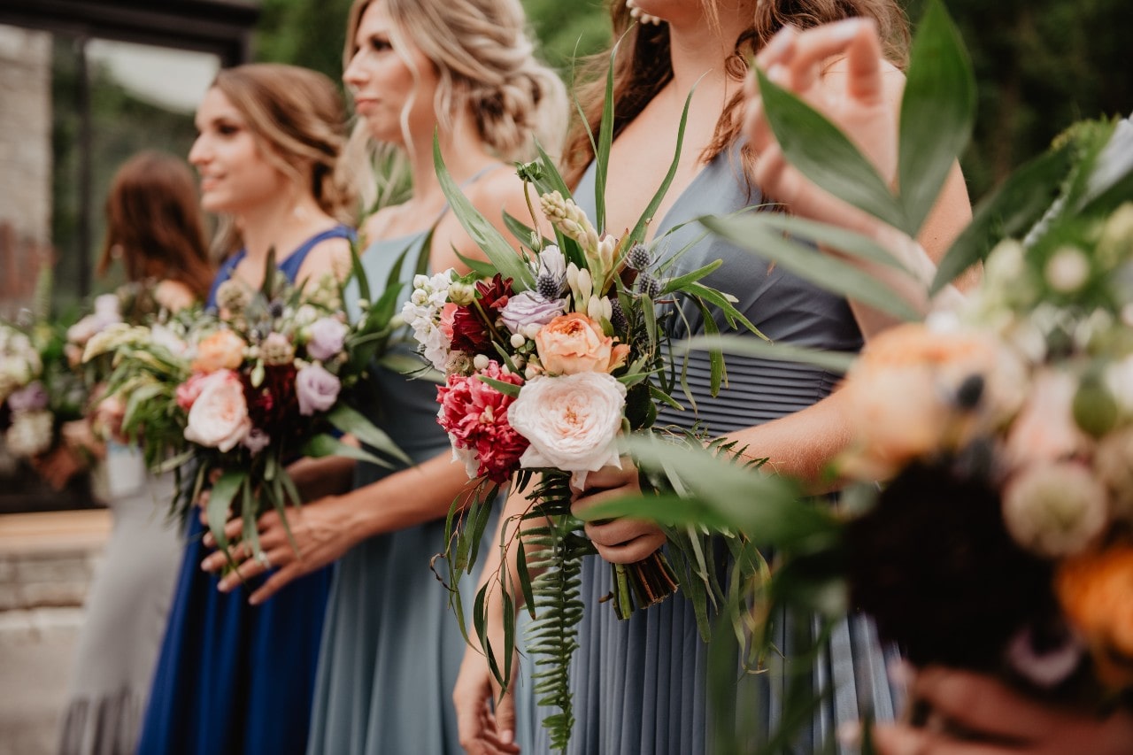 a line of ladies holding flowers
