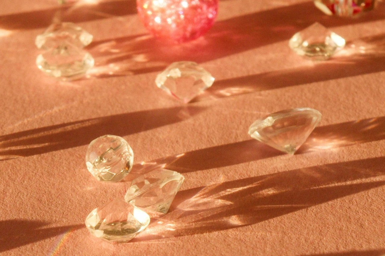 round cut diamonds sitting on a muted orange surface