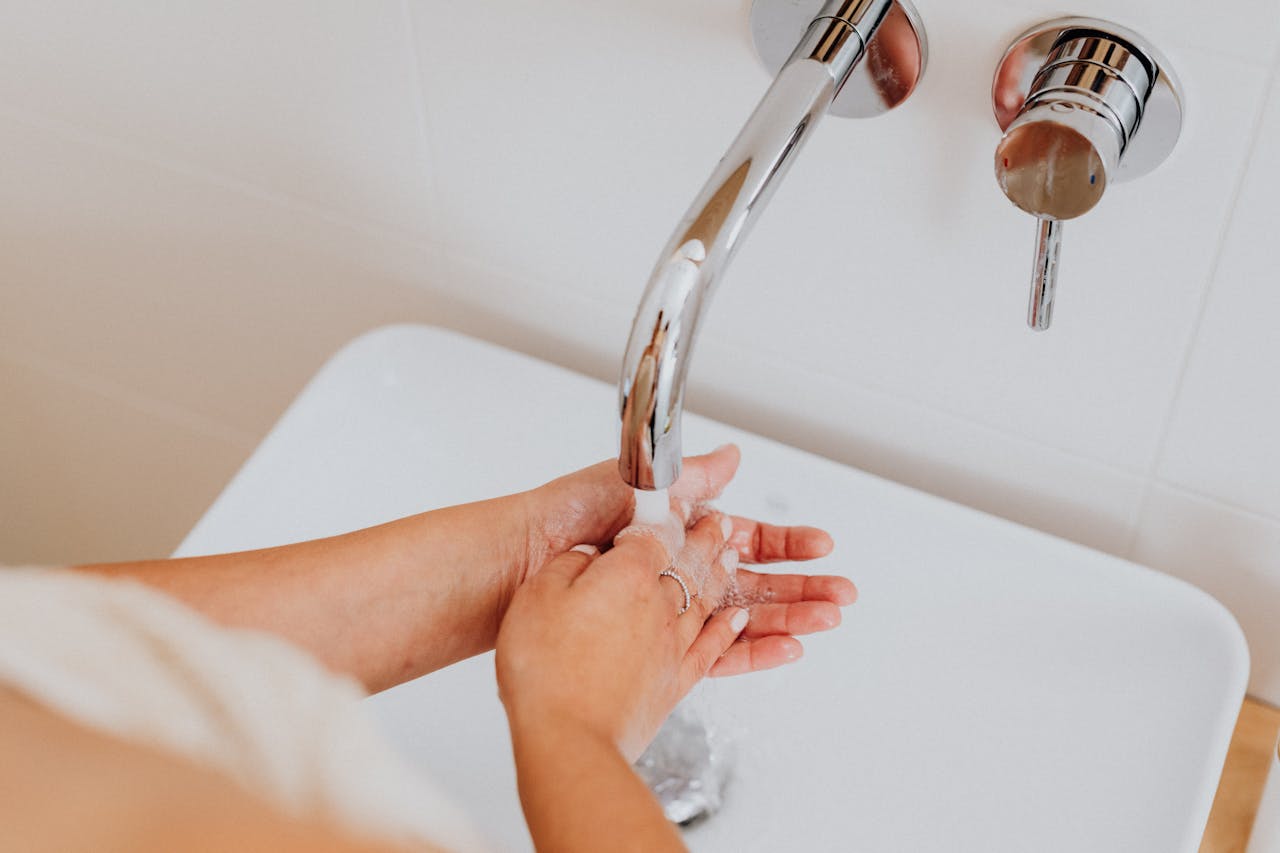 An overhead shot of a woman wearing her wedding band as she washes her hands.