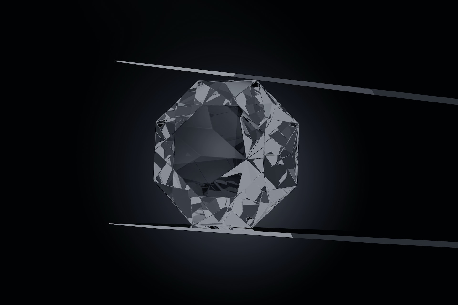 a diamond held between two prongs with a black background