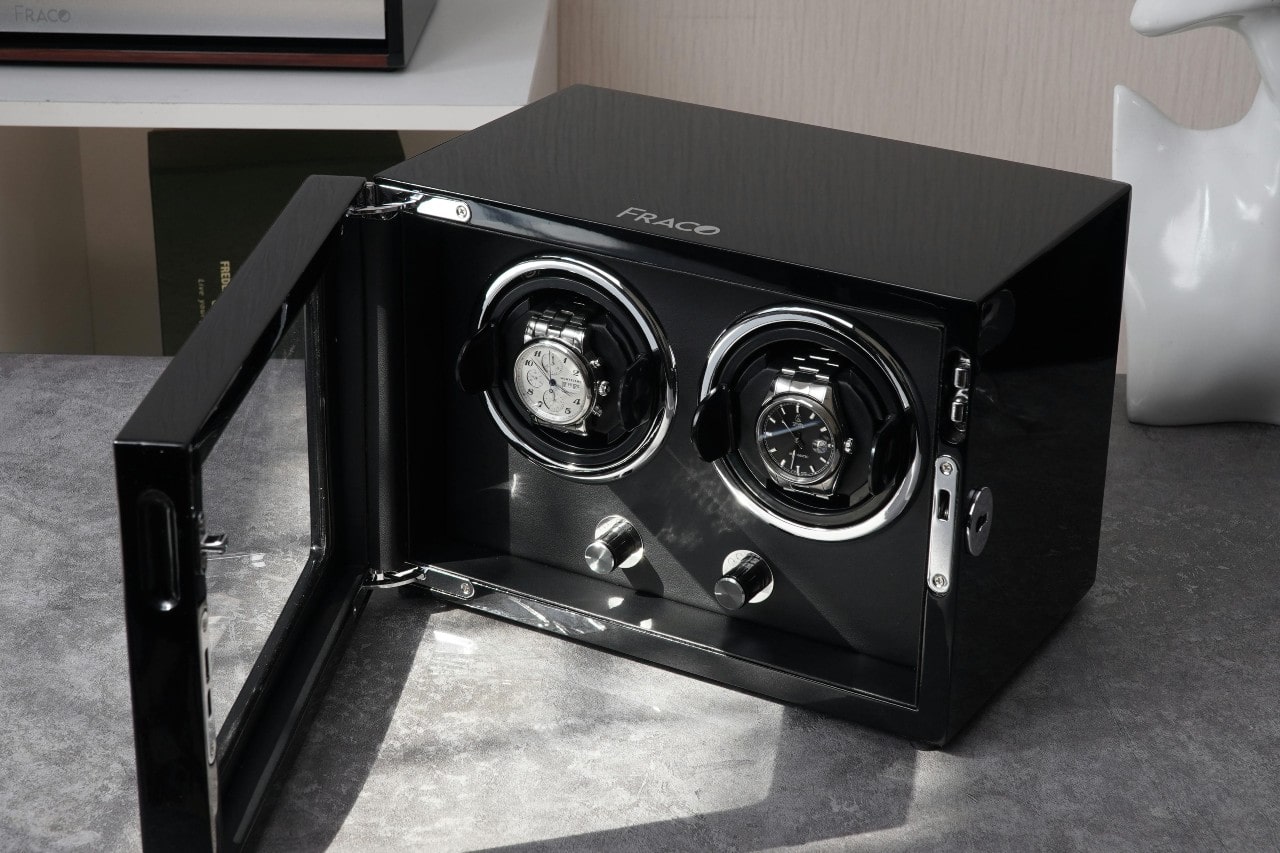 two watches in a black watch winder