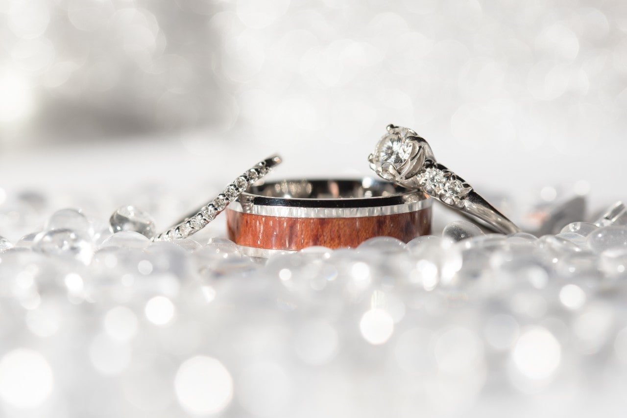 A man and woman’s wedding band, plus an engagement ring