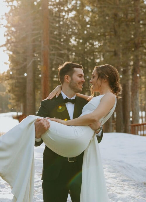 Brett and Kailey Collins A married couple. The man is carrying his wife in his arms.