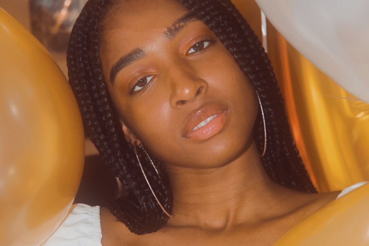 A woman at a party wearing diamond hoop earrings. A woman at a party wearing diamond hoop earrings.