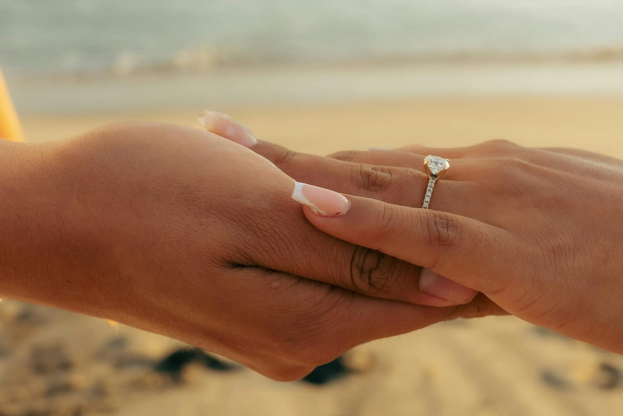close up of couple's hands wearing engagement ring close up of couple's hands wearing engagement ring
