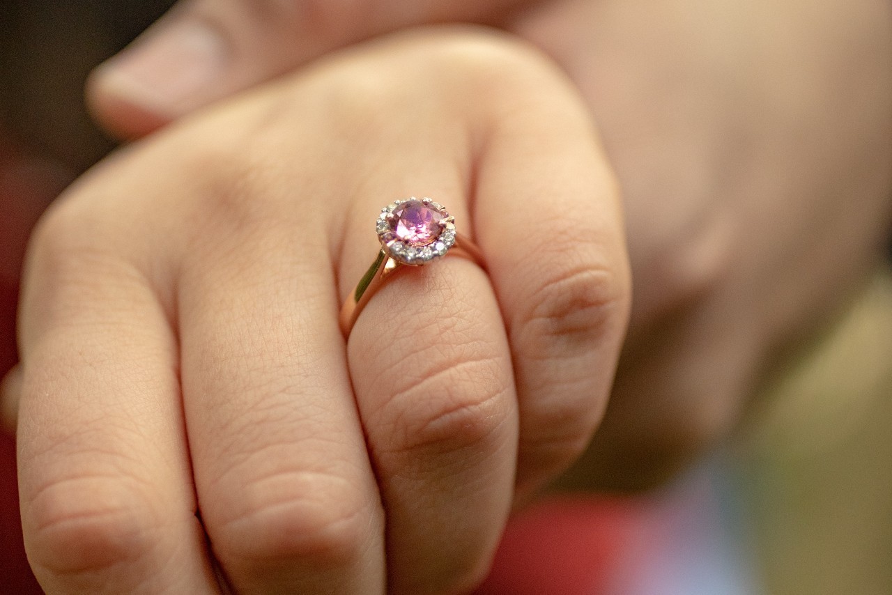 close-up of a hand wearing a diamond engagement ring