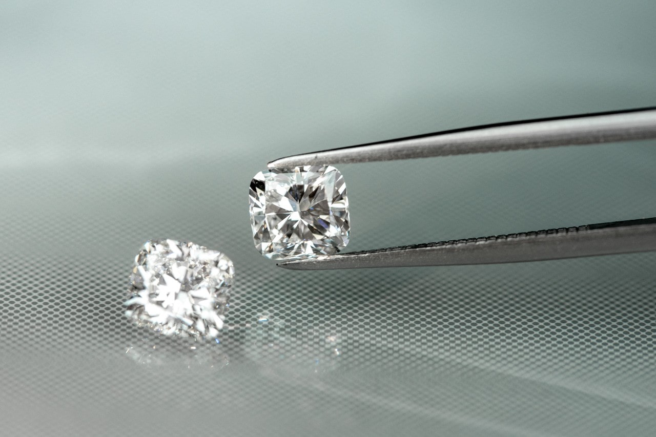 loose diamonds on display on mirrored table loose diamonds on display on mirrored table