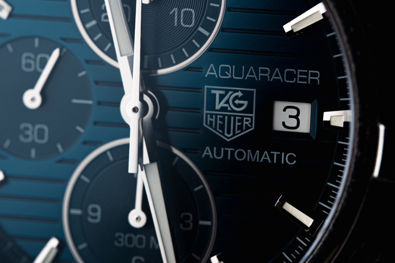 Close up image of a dark TAG Heuer Aquaracer dial