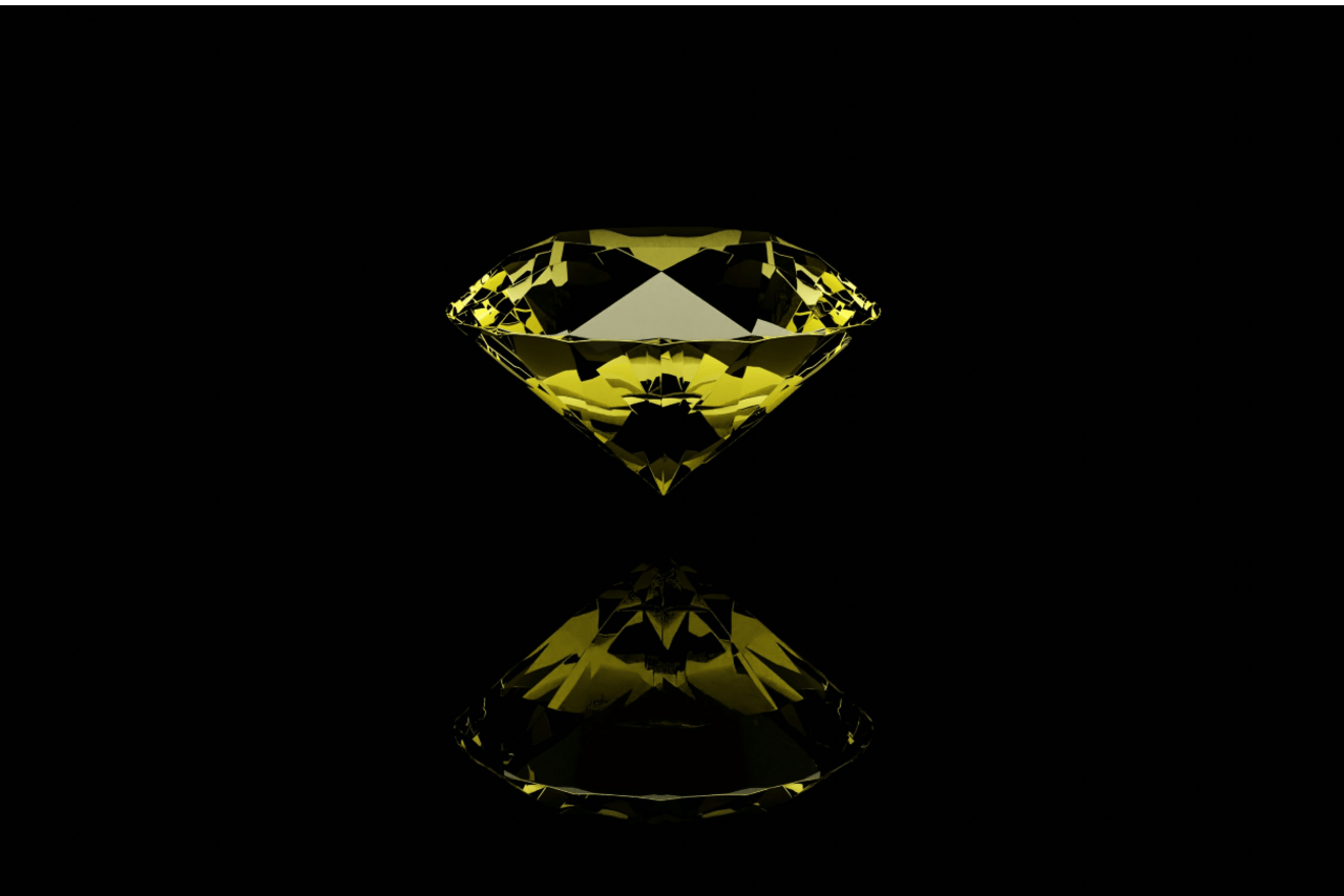 A close-up image of a yellow round cut diamond on a black background.
